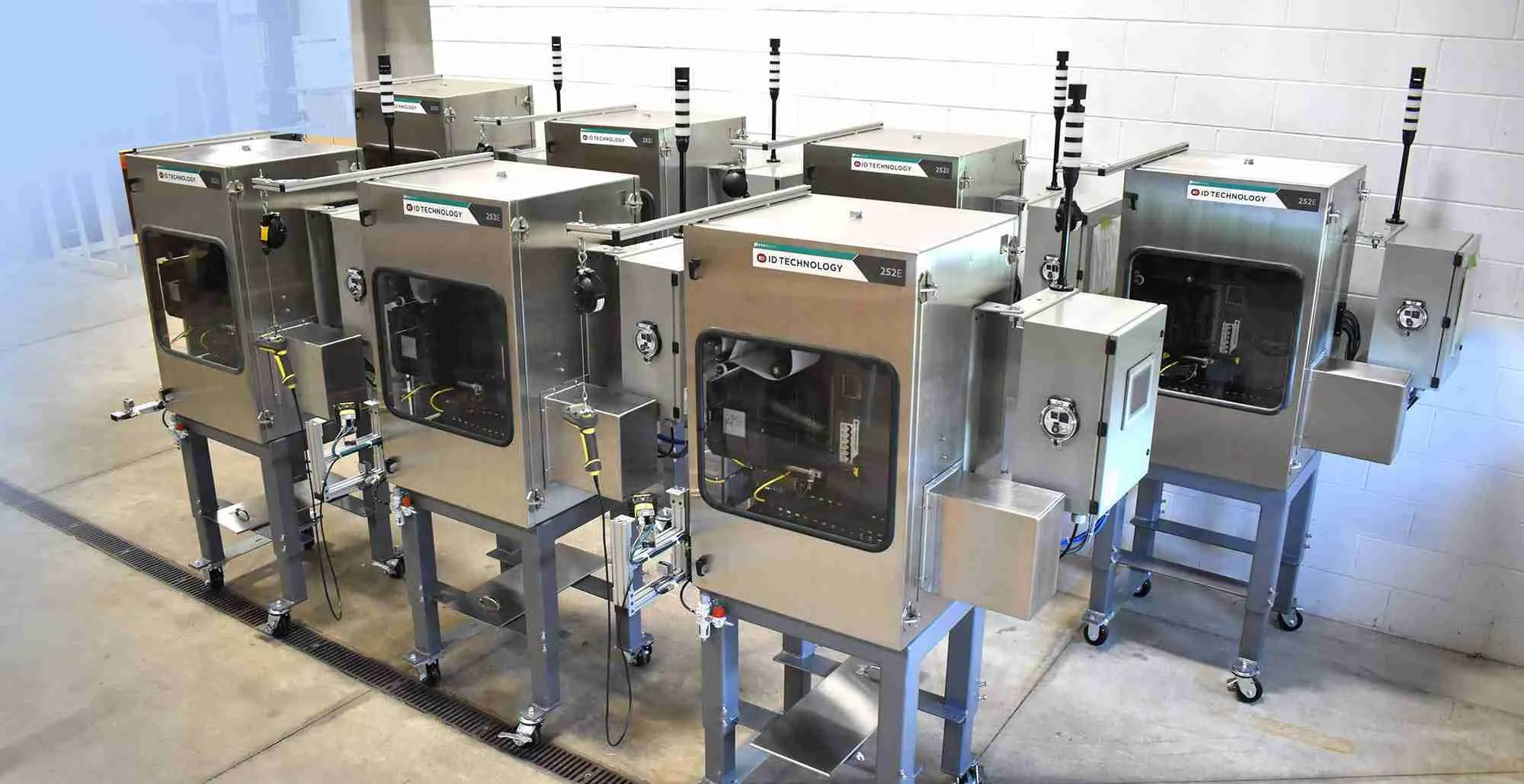 A production lineup of industrial print-and-apply labeling systems